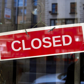Red closed sign on glass