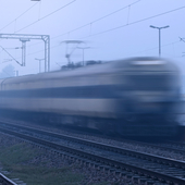 Train running in high speed blurred motion and crossing the station.