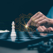 Human interacting with AI powered digital brain over chessboard representing machine learning strategy, data driven decision making and intelligent business planning.