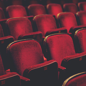Empty comfortable red seats with numbers in cinema - stock photo