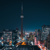 Futuristic and modern skyline views of downtown Toronto with the train tracks leading your eye to office buildings and condominiums.