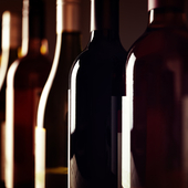 Bottles of old aged wine collection in a row in winery cellar