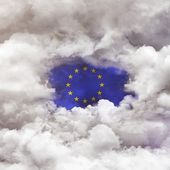 EU flag appearing through a gap in the clouds